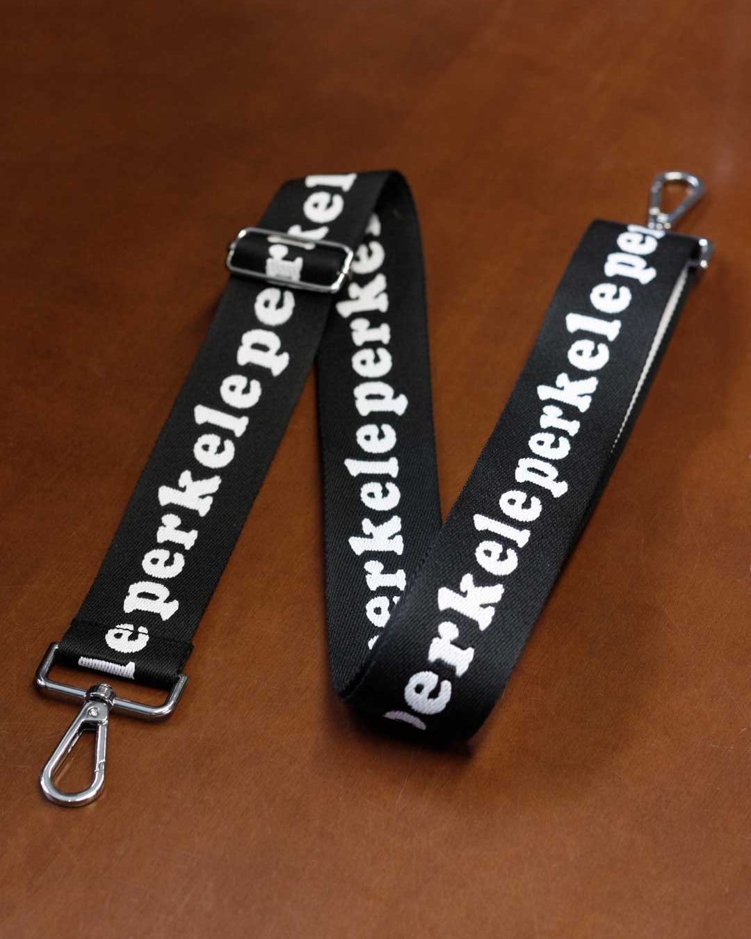 Black strap with white text on a brown surface